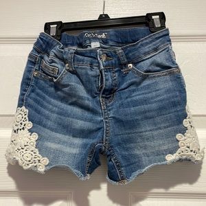 Denim cut off shorts with lace appliqué.